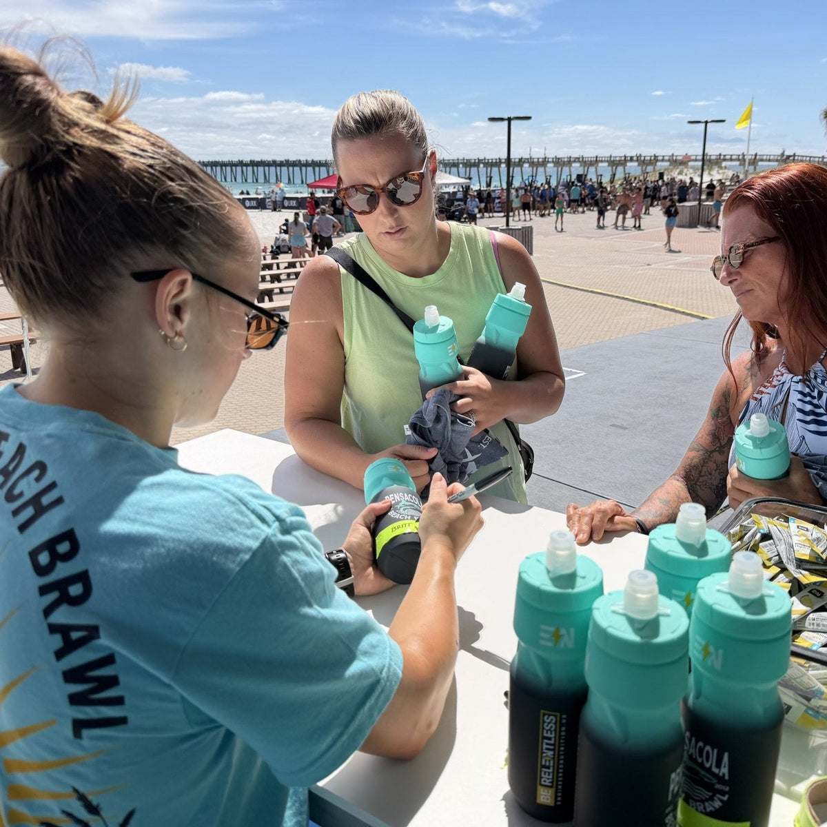 Athletes picking up Beach Brawl bottles at check-in