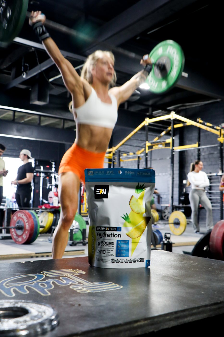 Overhead press in a CrossFit gym with the Engineered Nutrition bag