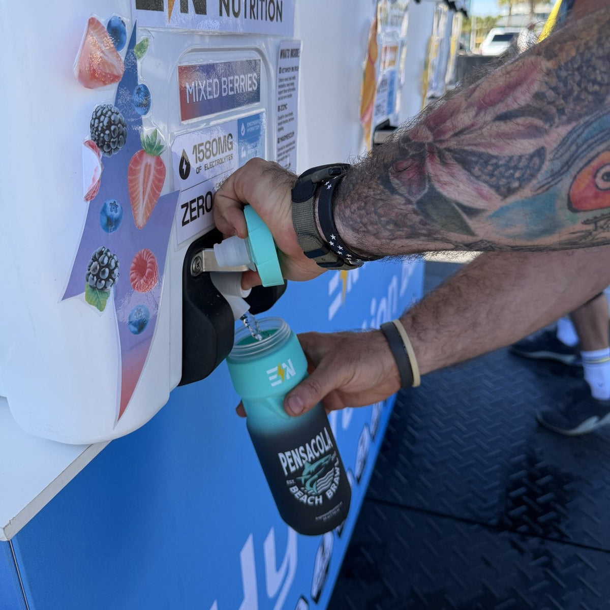 Athlete filling a Beach Brawl bottle at the EN Hydration Bar