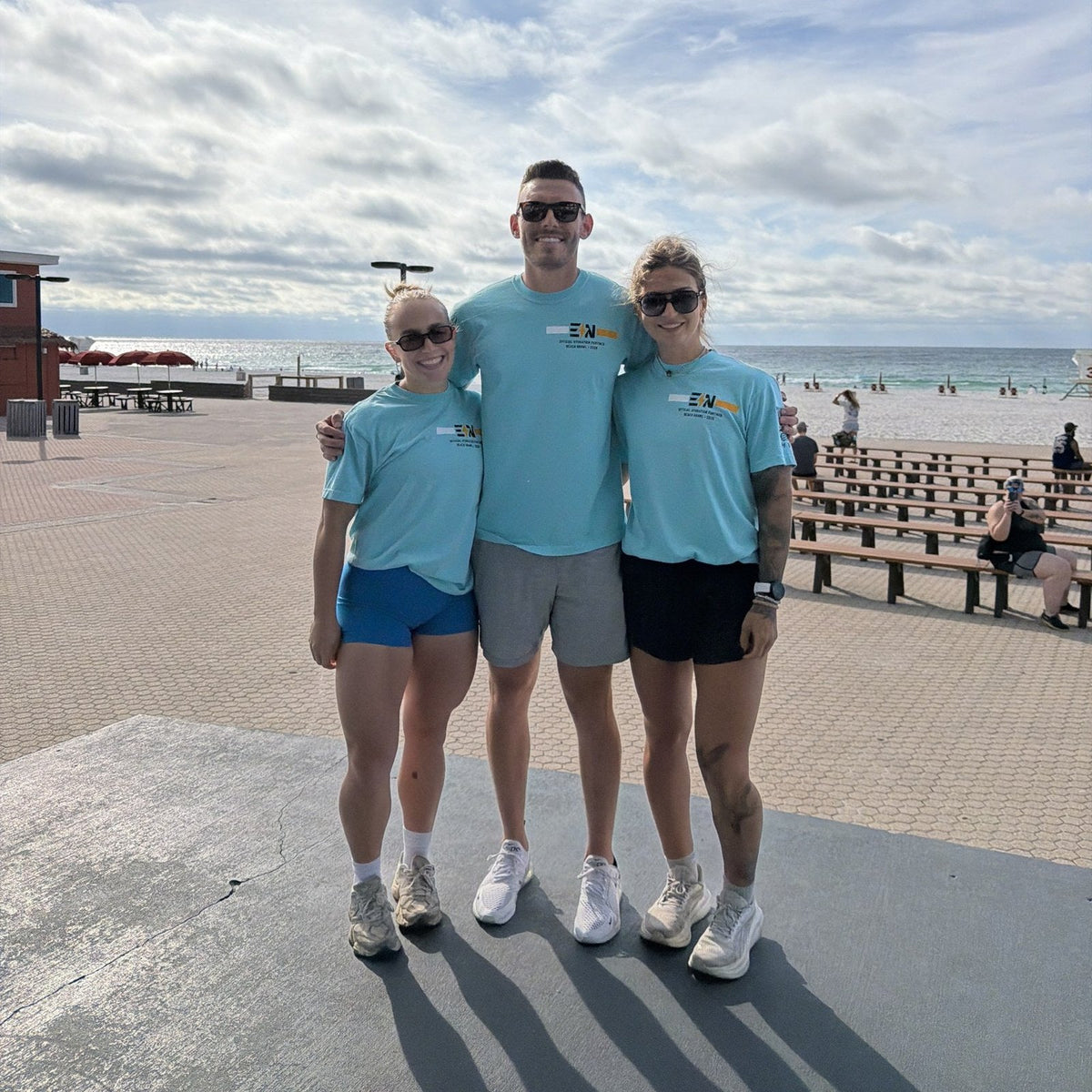 EN crew wearing the Beach Brawl tee on Pensacola Beach