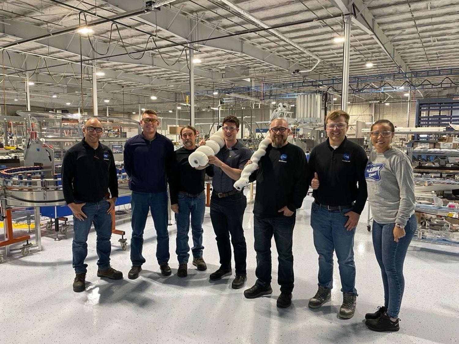 Nino with the co-pack team on the production floor